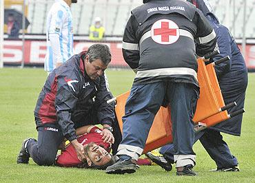 Piermario Morosini is attended to by medics after collapsing on the field on Saturday