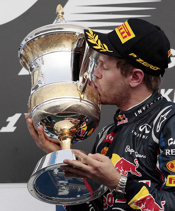 Red Bull's Sebastian Vettel kisses his trophy after winning the Bahrain F1 Grand Prix