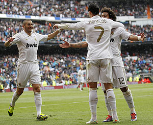 Real Madrid's Cristiano Ronaldo (centre) celebrates a goal with teammates Marcelo and Karim Benzema (left)