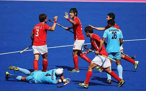 Nam Hyun Woo of South Korea celebrates with team mates after his goal during the Men's Hockey match between India and South Korea