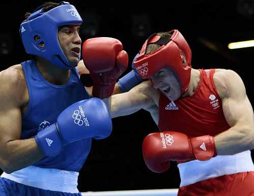 Manoj Kumar of India, left, and Thomas Stalker of Great Britain, fight during the men's light welterweight boxing competition