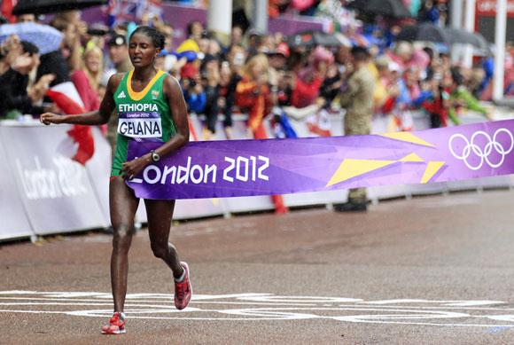 Ethiopia's Tiki Gelana crosses the finishing line as she wins the women's marathon final