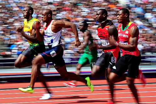 Usain Bolt of Jamaica competes in the Men's 100m Round 1 Heats