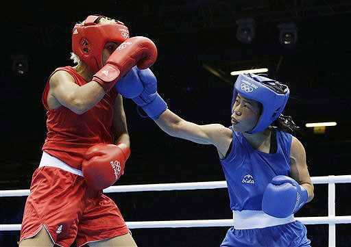 India's Mary Kom, right, fights Tunisia's Maroua Rahali during a women's flyweight 51-kg quarter-final boxing match