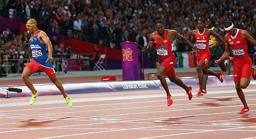 Felix Sanchez of Dominican Republic celebrates as he crosses the finish line to win the gold medal