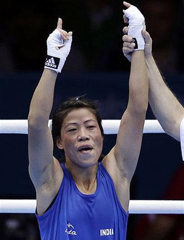 India's Chungneijang Mery Kom Hmangte celebrates after defeating Tunisia's Maroua Rahali in a women's flyweight 51-kg quarterfinal boxing match at the 2012 Summer Olympics