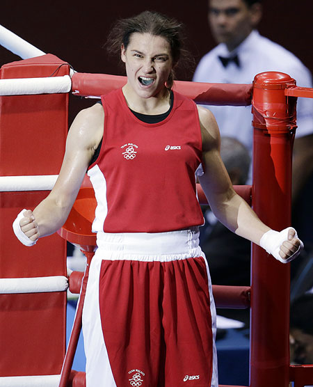 Ireland's Katie Taylor celebrates after defeating Britain's Natasha Jonas in a women's lightweight 60-kg quarterfinal boxing match on Monday
