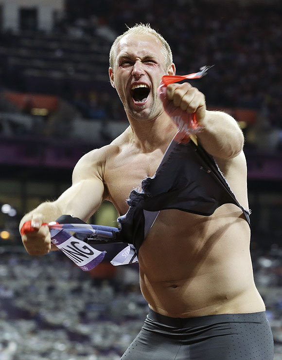 Germany's Robert Harting celebrates winning gold in the men's discus throw final on Tuesday