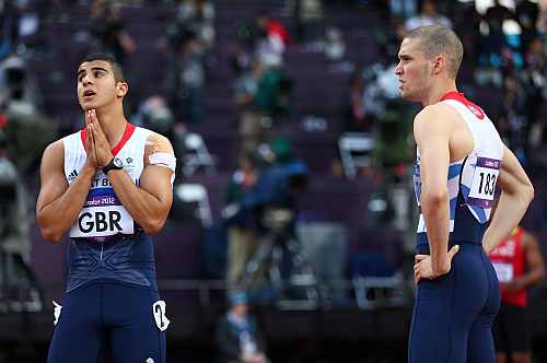 Adam Gemili of Great Britain reacts next to Daniel Talbot of Great Britain after the Great Britain team was disqualified during the Men's 4 x 100m Relay Round 1 heats