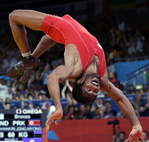 Yogeshwar Dutt celebrates after beating Ri Jong Myong to win bronze at the Rio Olympics