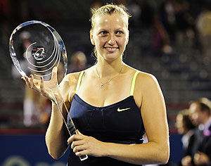 Petra Kvitova of the Czech Republic poses with the winner's trophy after defeating Li Na of China at the Montreal Open