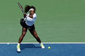 Serena Williams hits a backhand against Urszula Radwanska of Poland during their match at the Cincinnati Open in Mason, Ohio