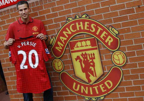 Manchester United's new signing Robin van Persie of the Netherlands poses for photographers at Old Trafford in Manchester