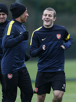 Arsenal's Alex Oxlade-Chamberlain (left) talks to Jack Wilshere