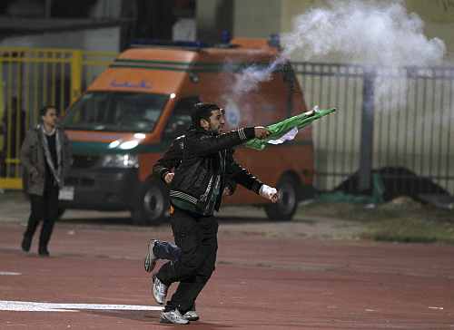 A soccer fan flees from the Port Said Stadium