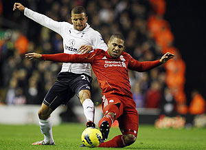 Liverpool's Glen Johnson (right) challenges Tottenham Hotspur's Kyle Walker during their English Premier League match at Anfield on Monday