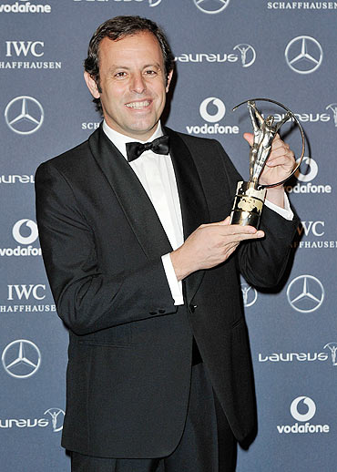 Sandro Rosell,Barcelona Chairman poses with the Laureus World Team of the Year trophy