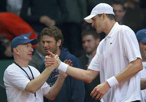 John Isner of the U.S. celebrates with his team members after winning his Davis Cup match against Federer of Switzerland in Fribourg