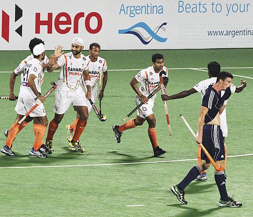 Sandeep Singh is congratulated by team-mates after scoring against France in the London 2012 Olympic Games men's hockey qualifying match in Delhi