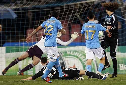 Napoli's Ezequiel Lavezzi scores against Chelsea during their Champions League last 16 first leg match at the San Paolo stadium