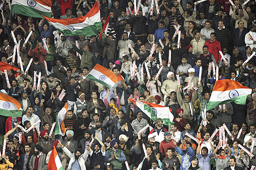 Fans wave India's national flag during the final