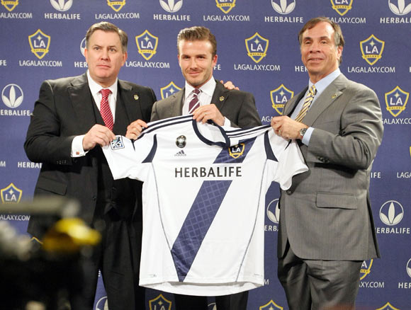 (L-R) President of AEG Tim Leiweke, David Beckham of the Los Angeles Galaxy and Head Coach Bruce Arena present Beckham with his new jersey at the Staples Center