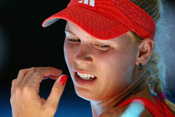 Caroline Wozniacki of Denmark reacts in her quarter final match against Kim Clijsters of Belgium during day nine of the 2012 Australian Open at Melbourne Park