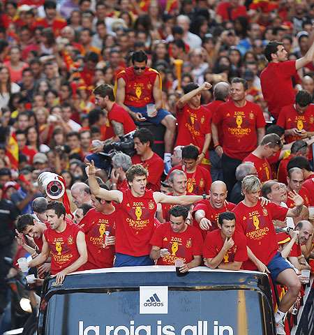 Spain's national soccer team players celebrate their Euro 2012 victory on an open top bus during a parade in downtown Madrid