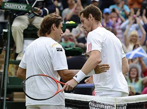Andy Murray shakes hands with David Ferrer after defeating him in their men's quarter-final match at the Wimbledon
