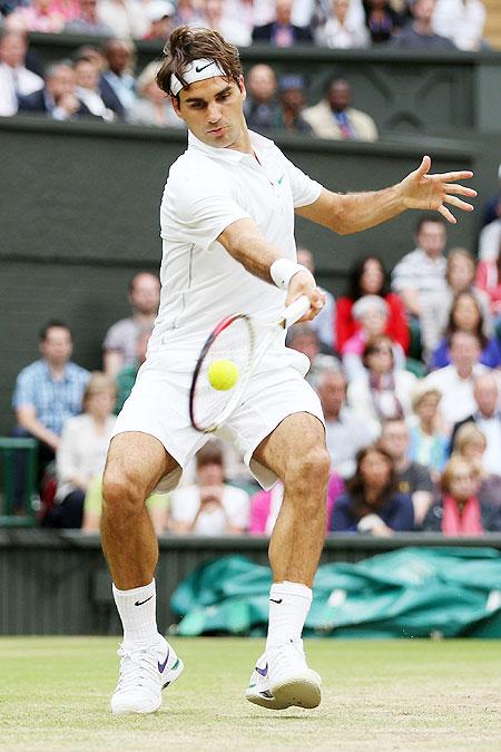 oger Federer of Switzerland hits a forehand return