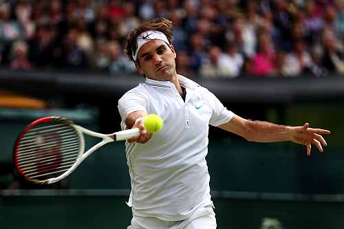 Roger Federer returns a shot during his Men's singles final match against Andy Murray at the Wimbledon