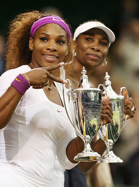 Serena Williams (left) and Venus Williams of the USA celebrate with their winners trophies