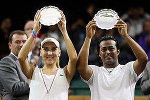 Elena Vesnina and Leander Paes hold up their runner up trophies after losing their Mixed Doubles final against Mike Bryan and Lisa Raymond on Sunday