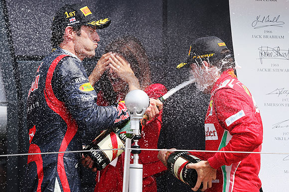 Mark Webber celebrates on the podium with second placed Ferrari driver Fernando Alonso on Sunday