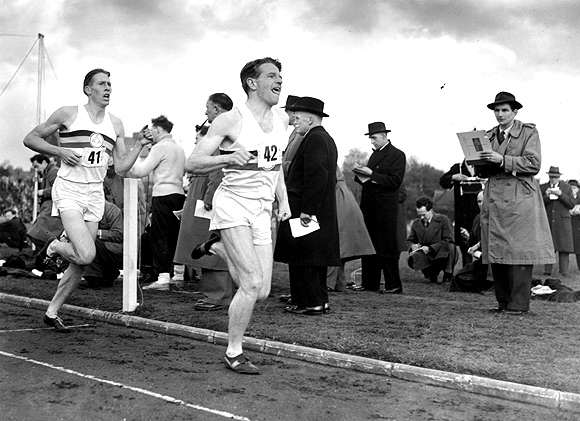 Britain's famed miler Roger Bannister (back) following pace man Chris Chataway, on the way to a new record of 3 minutes 59.4 seconds at Iffley Road, Oxford