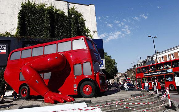 A London bus that has been transformed into a robotic sculpture by Czech artist David Cerny is assembled in front of the Czech Olympic headquarters in London