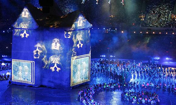 Performers dance to the music of the rock band Queen during the opening ceremony of the London Olympic Games at the Olympic Stadium on Friday