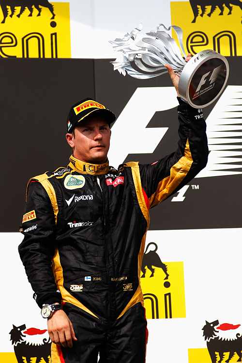Kimi Raikkonen of Finland and Lotus receives his trophy for finishing second during the Hungarian Formula One Grand Prix