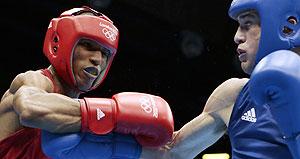 Great Britain's Josh Taylor, right, fights Brazil's Robson Conceicao during a lightweight 60-kg preliminary boxing match at the London Games on Sunday