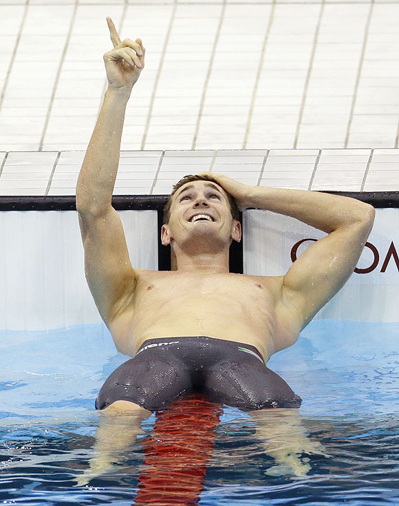South Africa's Cameron van der Burgh celebrates his gold medal win in the men's 100-meter breaststroke swimming final on Sunday
