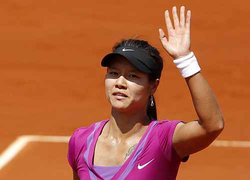 Li Na of China waves after winning her match against McHale of the U.S. during the French Open