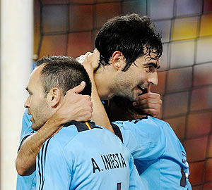Raul Arbeloa (centre) celebrates with Andres Iniesta and David Silva