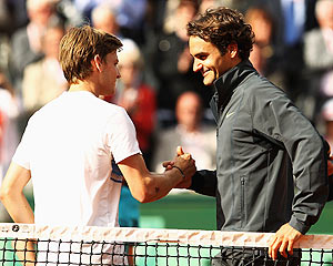 Roger Federer of Switzerland shakes hands with David Goffin of Belgium
