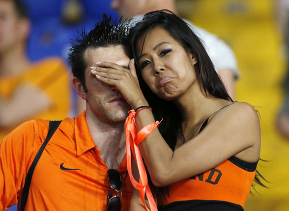 Netherlands' fans react at the end of their Group B Euro 2012 soccer match against Germany at the Metalist stadium in Kharkiv