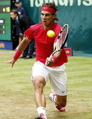 Rafael Nadal of Spain returns the ball to Lukas Lacko of Slovakia at the Halle Open