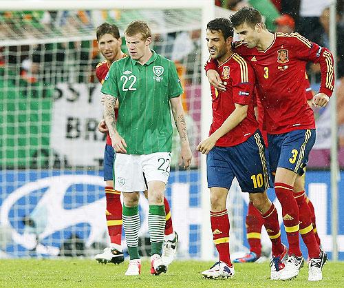 Spain's Fabregas celebrates with Pique after scoring a goal