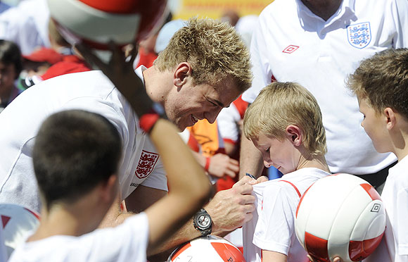 England's national goalkeeper Joe Hart signs autographs during a vist to a local sports school in Krakow on Sunday