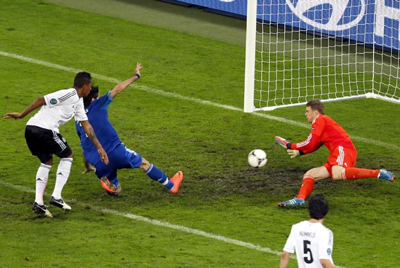 Giorgos Samaras (2nd left) scores the first goal for Greece beating Germany's goalkeeper Manuel Neuer