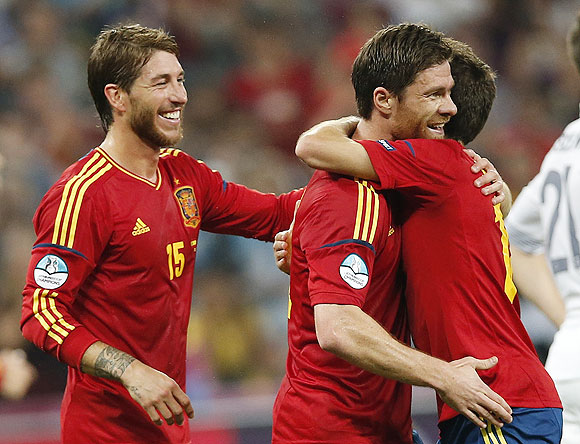 Spain's Xabi Alonso (centre) celebrates with teammates Jordi Alba (right) and Sergio Ramos after scoring against France