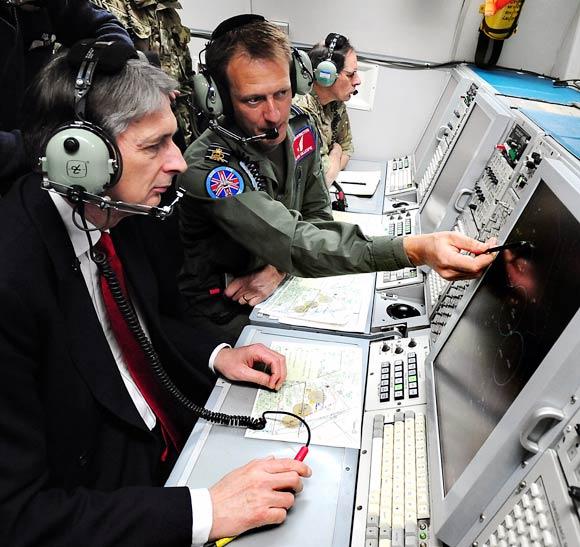 UK's Secretary of State for Defence Philip Hammond observes an Olympic training exercise during a flight on the E-3D Sentry aircraft in Lincoln, England